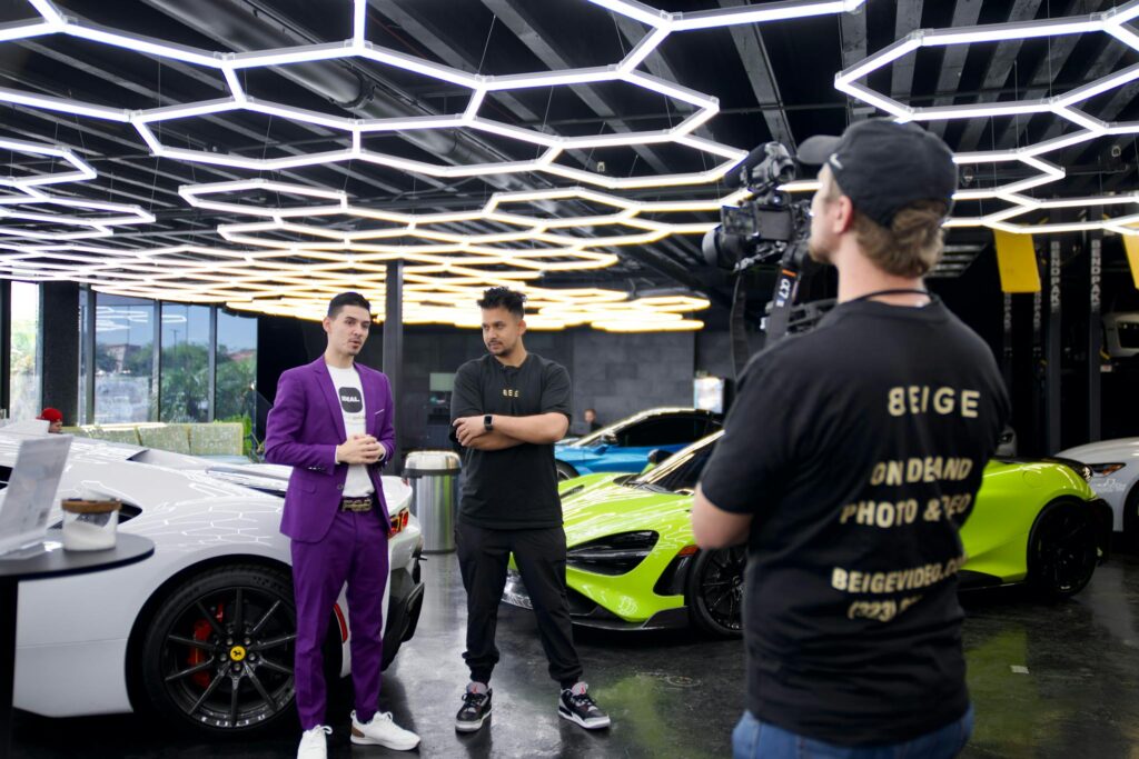 Behind-the-scenes filming of luxury cars in a Los Angeles showroom, showcasing high-end automotive video production.